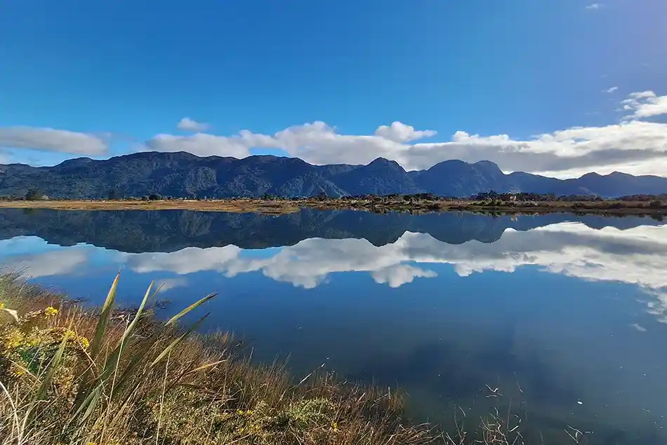 Burnett Range perfectly reflected in the Aorere River viewed from Collingwood