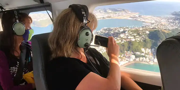 A passenger on a Golden Bay Air flight taking a photo of Oriental Bay as the aircraft flies over Wellington