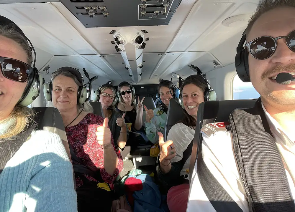 Passengers in Airvan giving thumbs up to camera