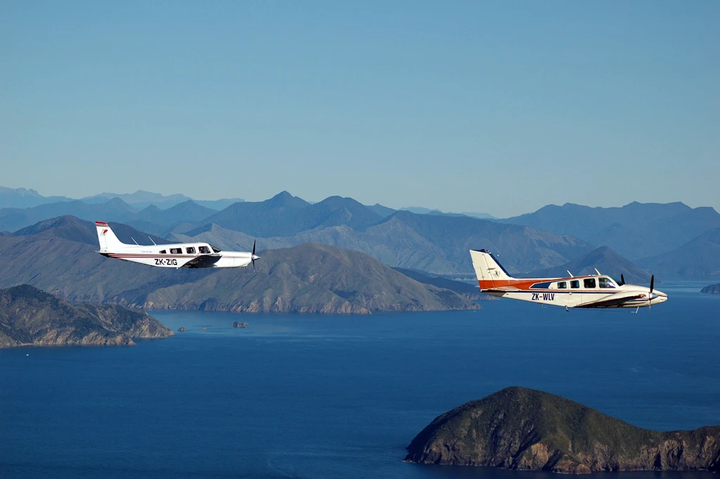 Capital Air Fleet Saratoga ZK-ZIG and Baron ZK-WLV flying together over Marlborough Sounds