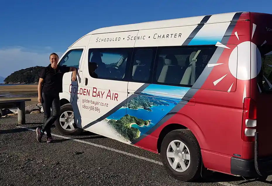 Golden Bay Air shuttle at Marahau with driver posing