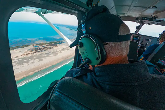 Passenger viewing Farewell Spit through Airvan window